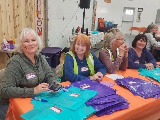 Welcome crew greeting attendees at Harvest Festival