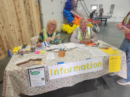 Two women running an information table