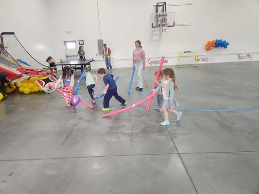Children playing with pool noodles