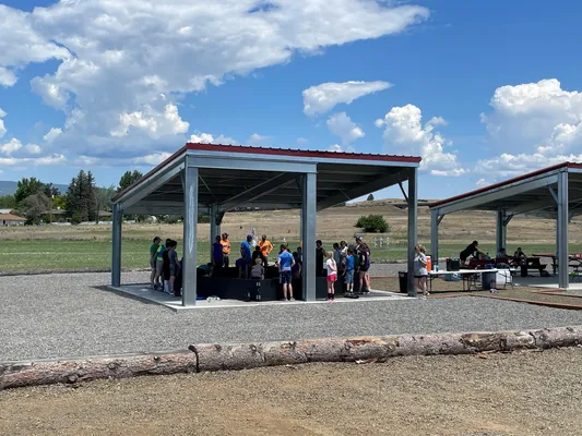 Youth gathered under a covered area.