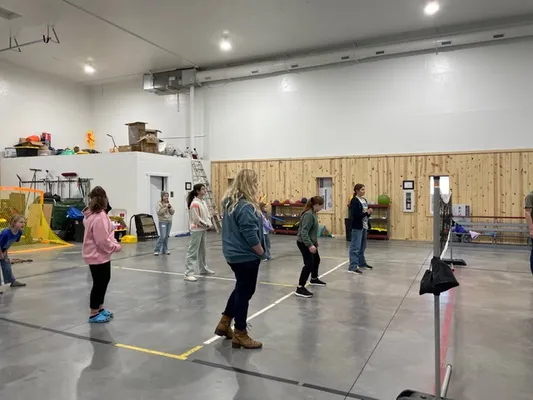 Youth gathered near a volleyball net