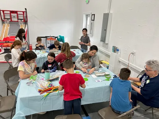 Kids working with a variety of arts and crafts materials