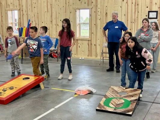Youth playing cornhole with beanbags