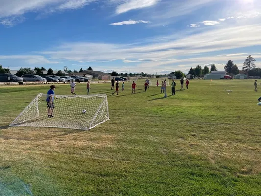 Youth outside playing soccer