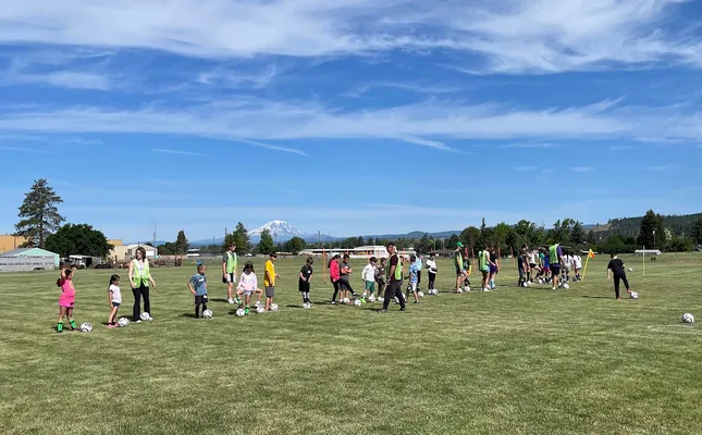 Youth participating in soccer camp activities